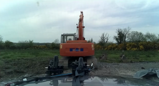 Camera view: a tracked excavator on gravel